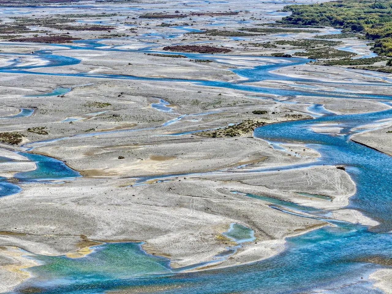 Aerial view of a braided turquoise river system
